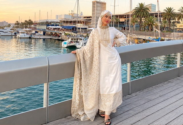 Woman wearing a lightweight Indian suit styled with a festive dupatta and traditional accessories